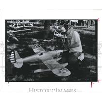 1990 Press Photo Enthusiast pampers his Model Airplane before flight - hca05905