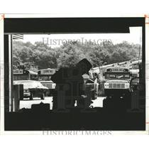 1981 Press Photo Jim Miller fixes starter on a school bus, Jefferson County, AL