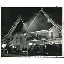 1986 Press Photo New Orleans firefighters battle a blaze on North Rampart Street