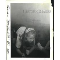 1992 Press Photo Jamie Fortenberry crawls on floor of smoke filled Safe House.
