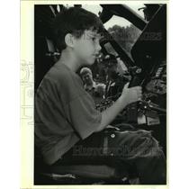 1992 Press Photo Brian Givens sits at the controls of a U.S. Customs helicopter
