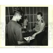 1994 Press Photo Craig Vucinovich gets target checked at Firearm Safety Course.