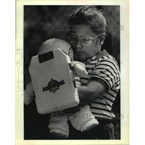 1988 Press Photo Kelly Latham of Jefferson Elementary School hugs her space doll