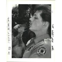 1993 Press Photo Captain Donald Lamartiniere of Kenner Fire Dept. rescues a dog
