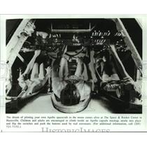 Press Photo Visitors inside Apollo capsule mockup at Space & Rocket Center, AL