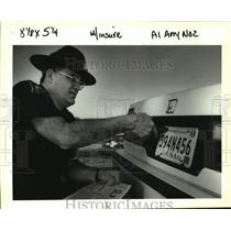 1993 Press Photo Charles Saltaformaggio removes car plate of April Marquize