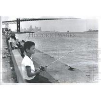1972. Press Photo A Young Boy Fishing The Detroit River