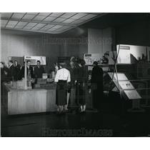 1957 Press Photo Visitors study Marshall plan display at Amerika house in Essen