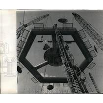 1965 Press Photo 2 cranes and tall fire ladder aid to raise Space Platform.
