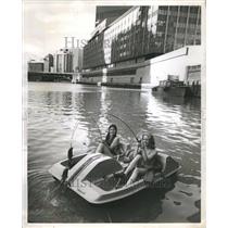 1973 Press Photo Two bikini clad ladies in a paddle boa