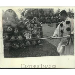 1965 Press Photo Japanese man burns a pile of spirit masks, Japan - mjb98946
