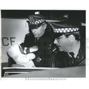 1993 Press Photo  policemen carries an abandon baby