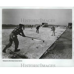 1968 Press Photo Workers cover a section of runway with crushed ice for NASA.