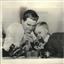 1953 Press Photo John Noble And Nephew Work On Camera At Home In Detroit