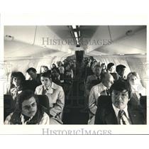 1987 Press Photo Passengers inside an Aircraft
 - hca04743