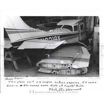 1986 Press Photo plane waits repairs hanger swamp area