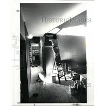 1988 Press Photo Norman Skizenta Hangs Wallpaper in House on Main Street USA