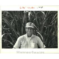 1988 Press Photo New Iberia sugar cane farmer Wayne Freyou next to his crops
