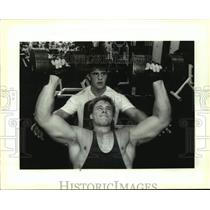 1993 Press Photo Butch Jeansonne spots Greg Nichols during dumbbell bench press