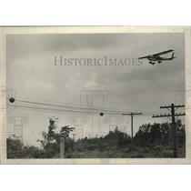 1970 Press Photo Small plane flies over the Schenectady New York County Airport.