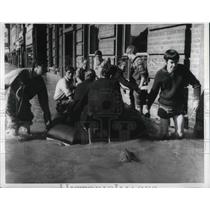 1968 Press Photo kids helping the police move a boat along a flooded street.