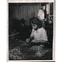 1947 Press Photo A young Siamese girl files down pieces of type for the boy to