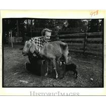 1988 Press Photo Jake Hines helps a newborn goat nurse