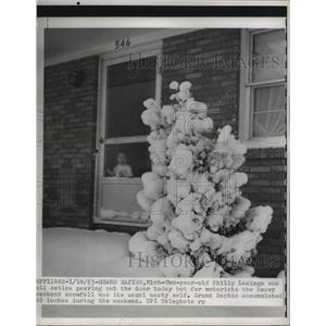1963 Press Photo Philip Lanings looks out at all the snow in Gran Rapids, Mich.