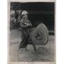1923 Press Photo Japanese Girl used old bellows fan to blow the chaff.