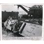 1950 Press Photo Salvage workers remove sacks of products after the accident